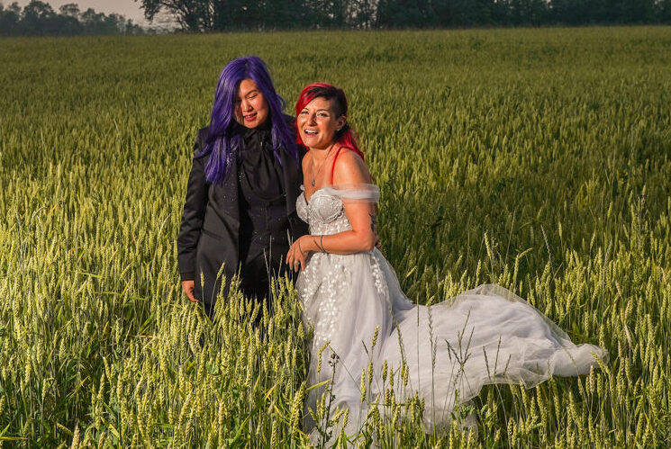 Newlyweds walking together through the fields at Fermanagh Farms