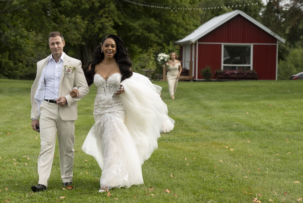 Newly married couple walking across the lawn at Fermanagh Farms