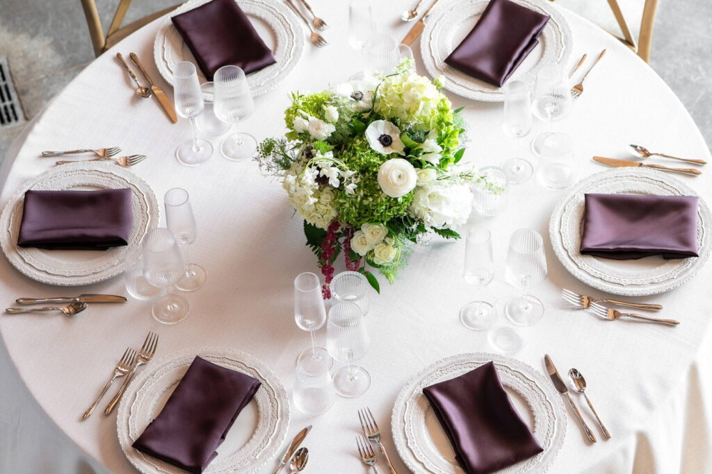 Wedding table setting with white and green florals
